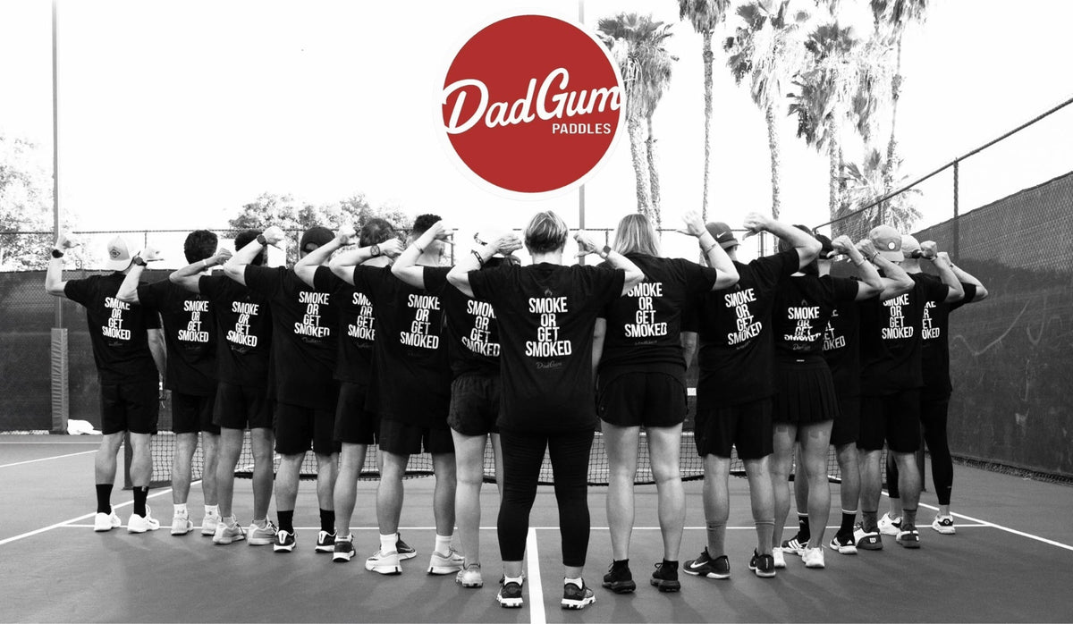 DadGum Paddles logo over the Bakersfield Ballers team huddle